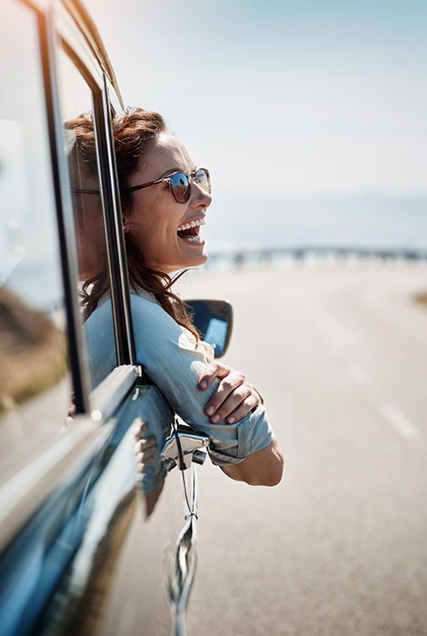 Woman leaning out of a car