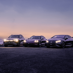 Front view of a silver Audi, a purple Porsche and a black Mercedes-Benz..