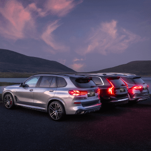 Rear view of a silver BMW, a black Volvo and a silver Mercedes-Benz.