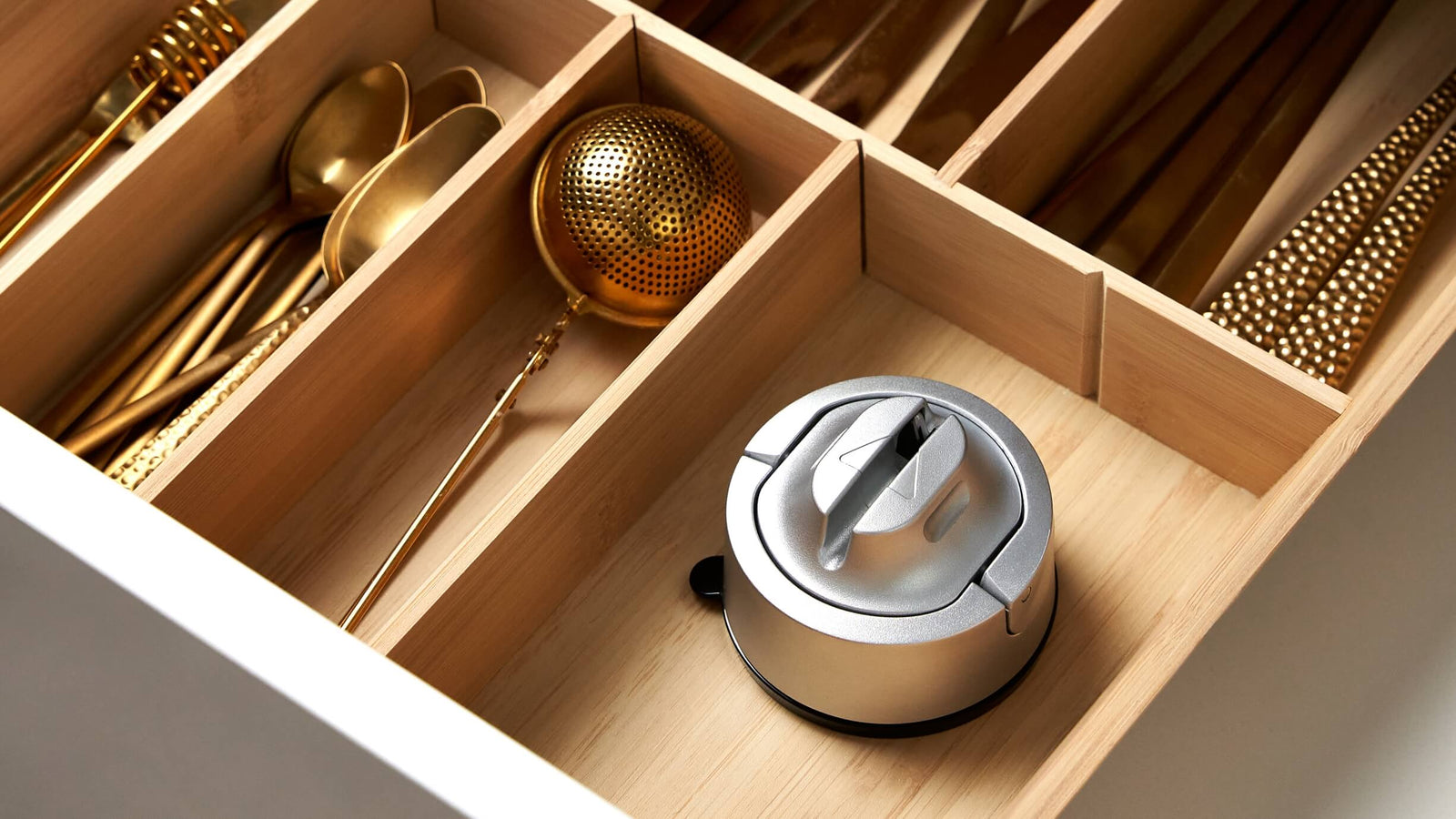 Compact AnySharp suction-base knife sharpener stored in a kitchen drawer
