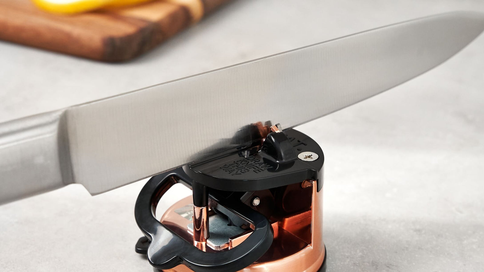 AnySharp knife sharpener being used to sharpen a kitchen knife
