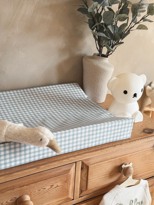 Neutral nursery featuring a Mabel & Fox blue gingham changing mat, wooden nursery furniture and beautiful nursery accessories