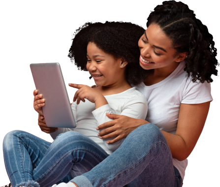 Mother and daughter sitting down and happily using an ipad together